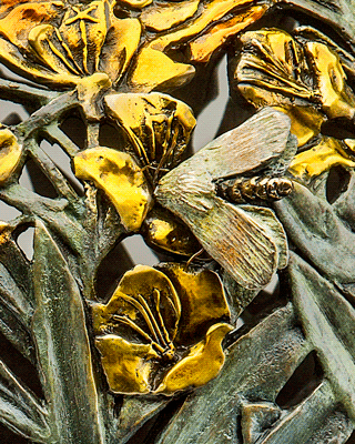 A Bronze Vessel Featuring the Primrose moth and flower.